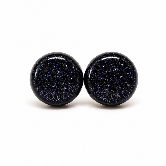 Pair of black glittery round earrings on a white background