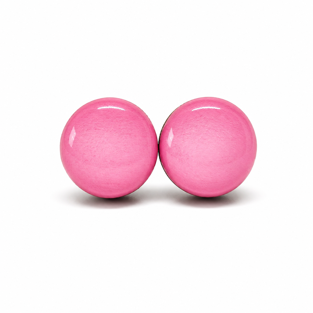 Two pink round objects on a white background