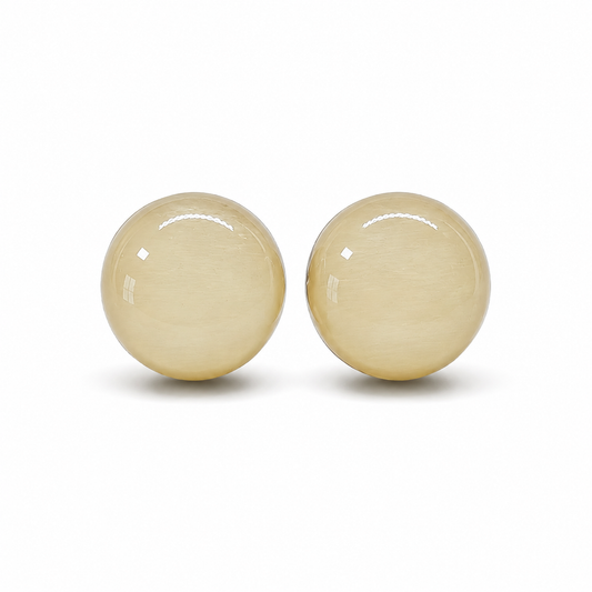 Pair of beige round earrings on a white background
