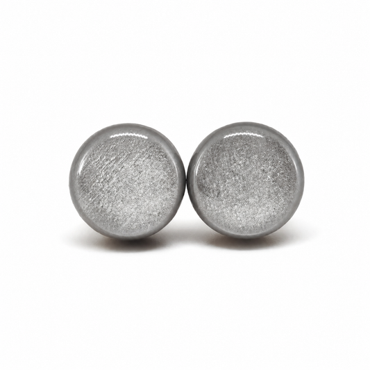 Pair of round silver earrings on a white background