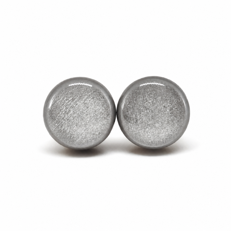 Pair of round silver earrings on a white background