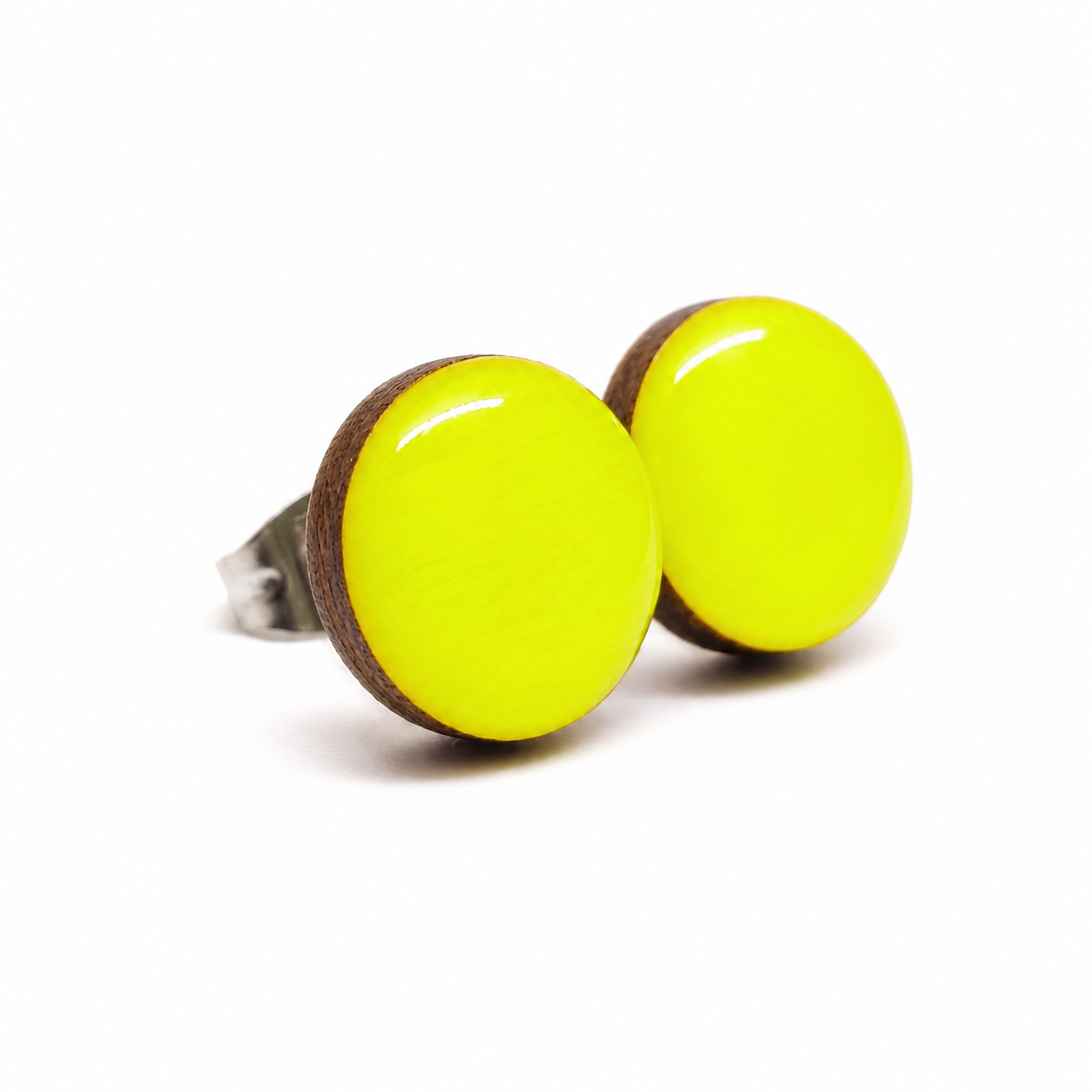 Pair of round neon yellow earrings with wooden accents on a white background