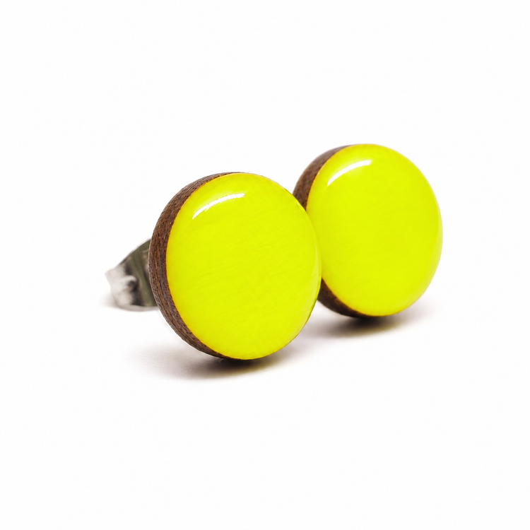 Pair of round neon yellow earrings with wooden accents on a white background