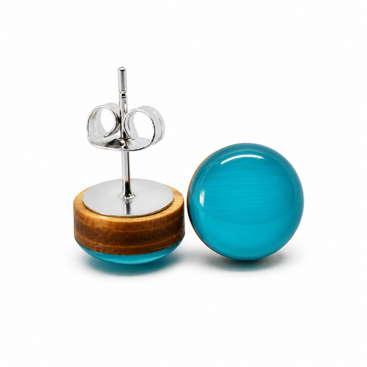 Pair of earrings with turquoise glass and wooden base on a white background