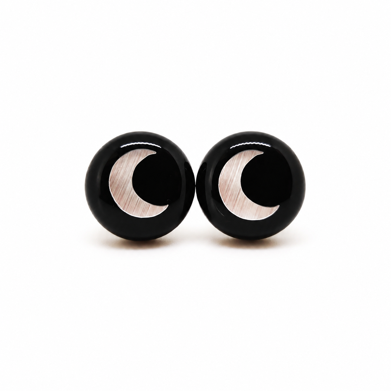 Black earrings with a crescent moon design on a white background