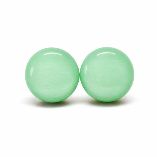 Two green earring studs with a brand name on a white background