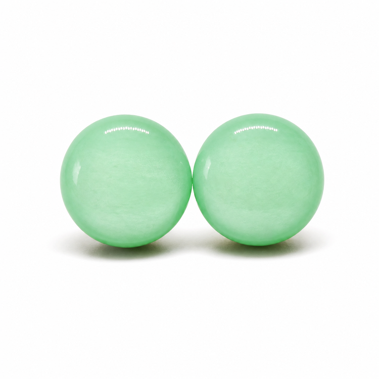 Two green earring studs with a brand name on a white background
