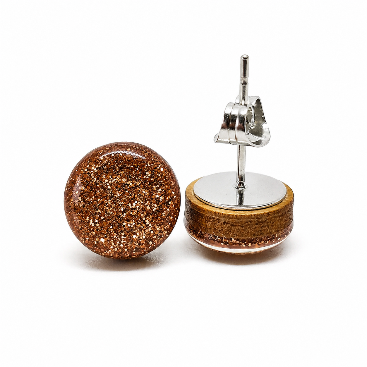 Gold glittery round earrings on a white background