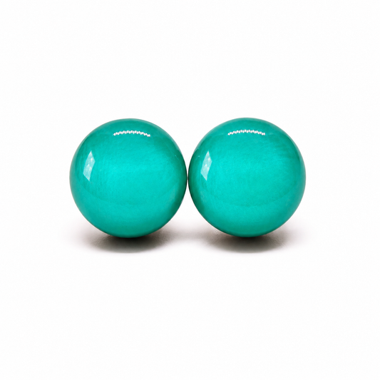 Two turquoise balls with a brand name on a white background